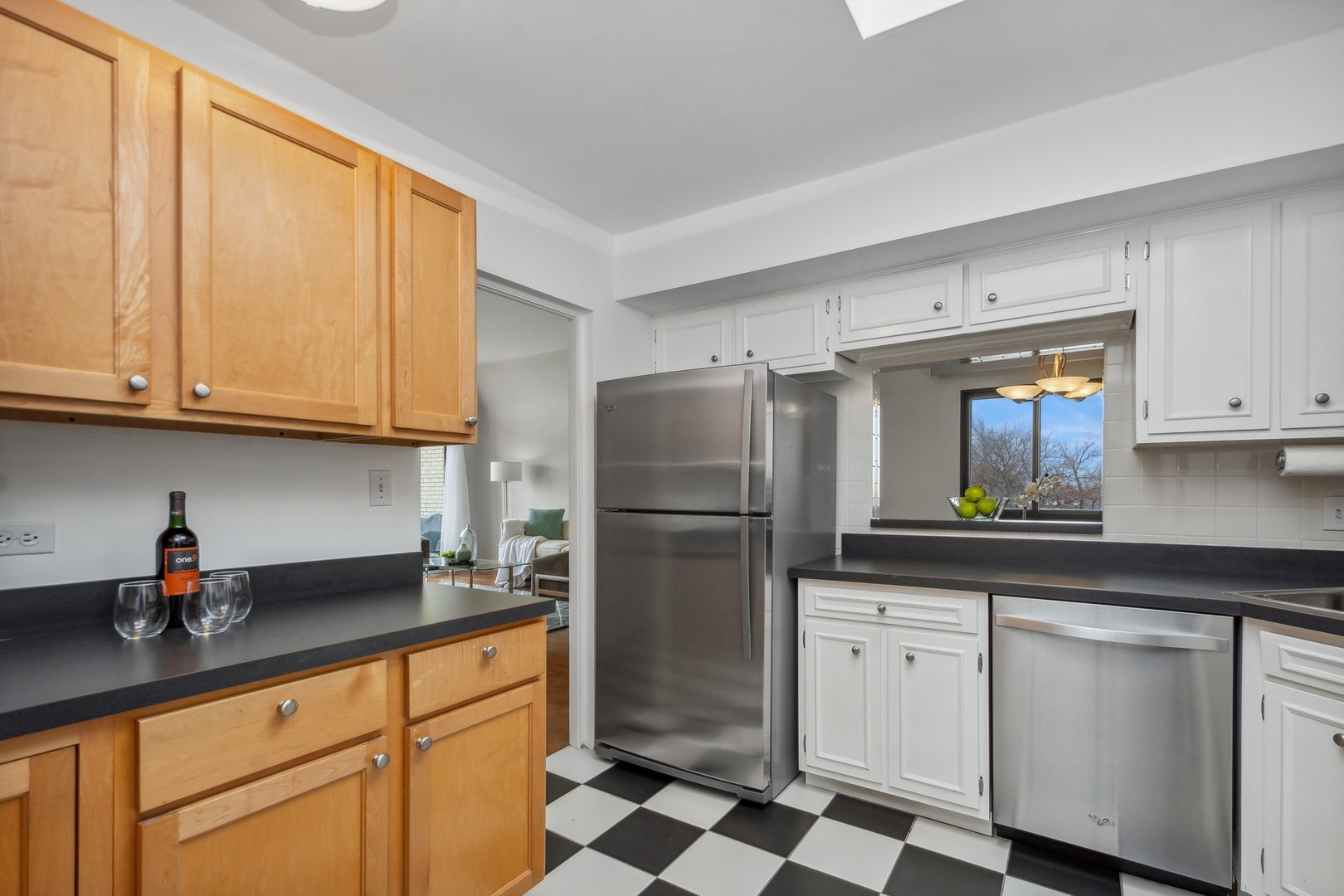 7200 North Ridge Boulevard, Unit 4E Chicago, IL 60645 - Photo 9 of 21 a kitchen with stainless steel appliances granite countertop a refrigerator sink and cabinets