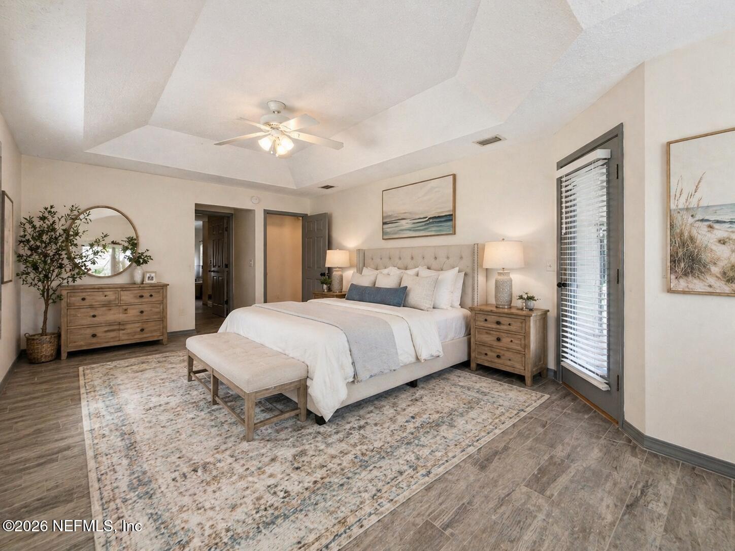 4728 Innisbrook Court North Elkton, FL 32033 - Photo 18 of 28 a bedroom with a large bed and a chandelier
