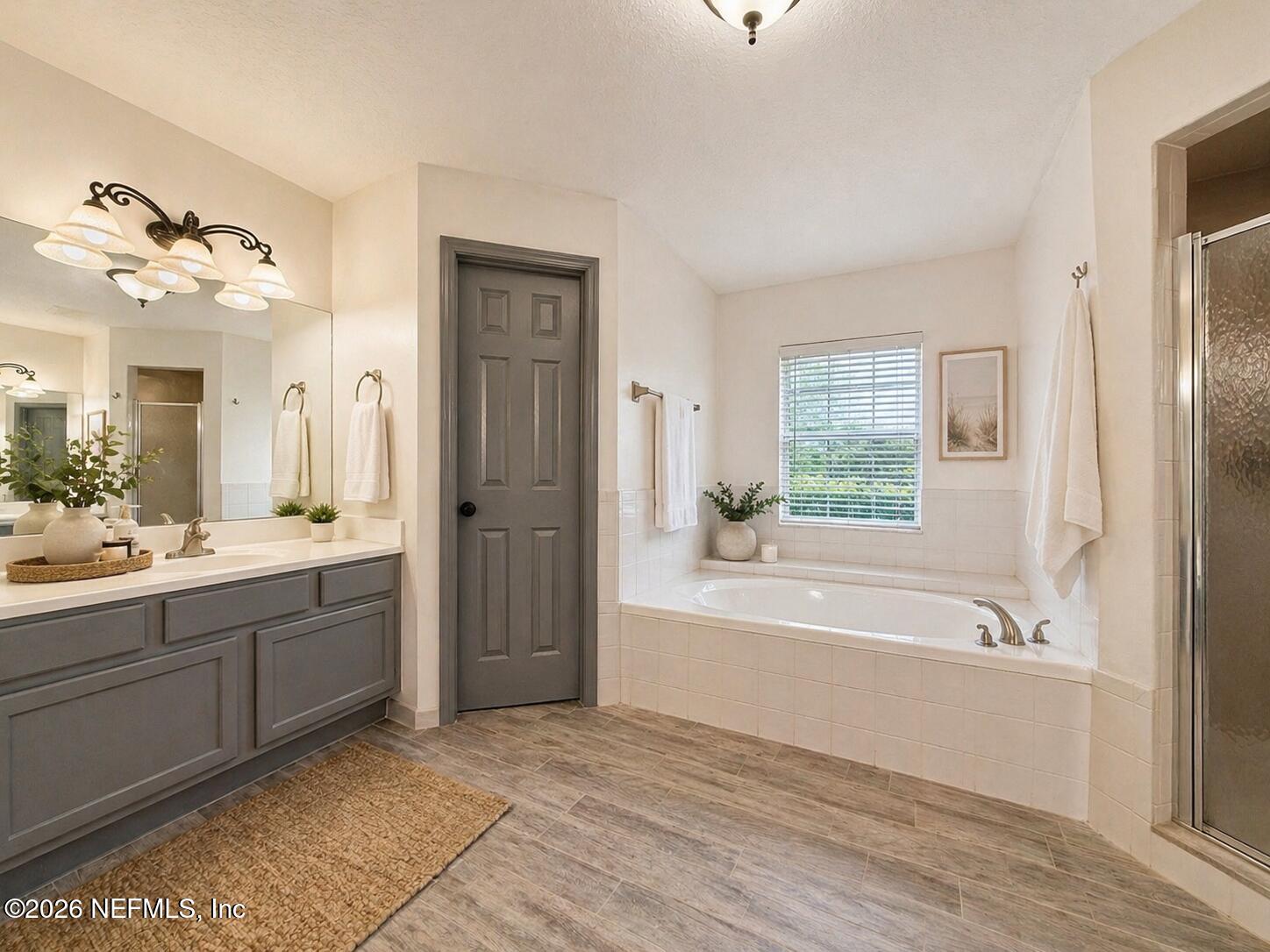 4728 Innisbrook Court North Elkton, FL 32033 - Photo 20 of 28 a spacious bathroom with a tub sink and mirror