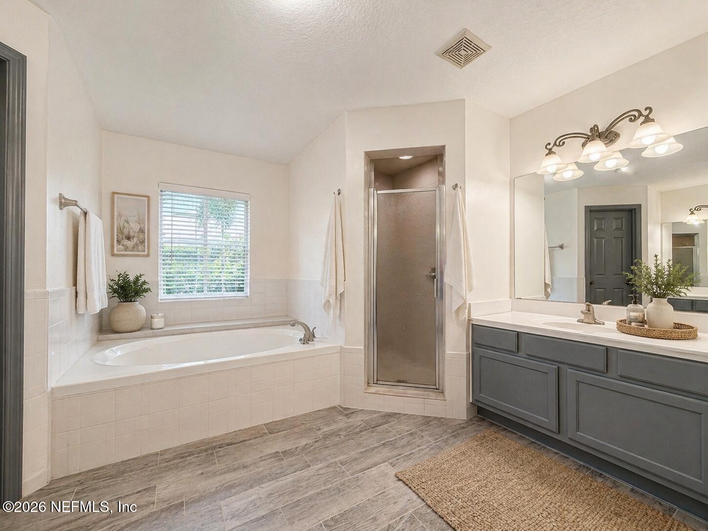 4728 Innisbrook Court North Elkton, FL 32033 - Photo 21 of 28 a bathroom with a tub sink and mirror