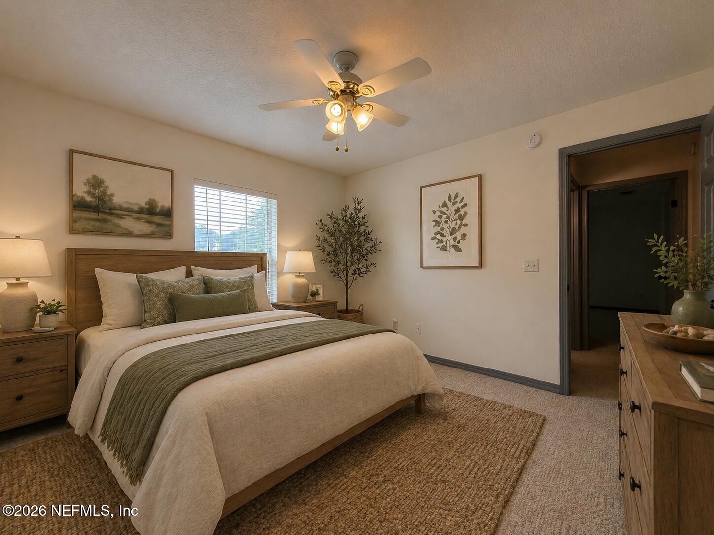 4728 Innisbrook Court North Elkton, FL 32033 - Photo 22 of 28 a spacious bedroom with a bed and a chandelier