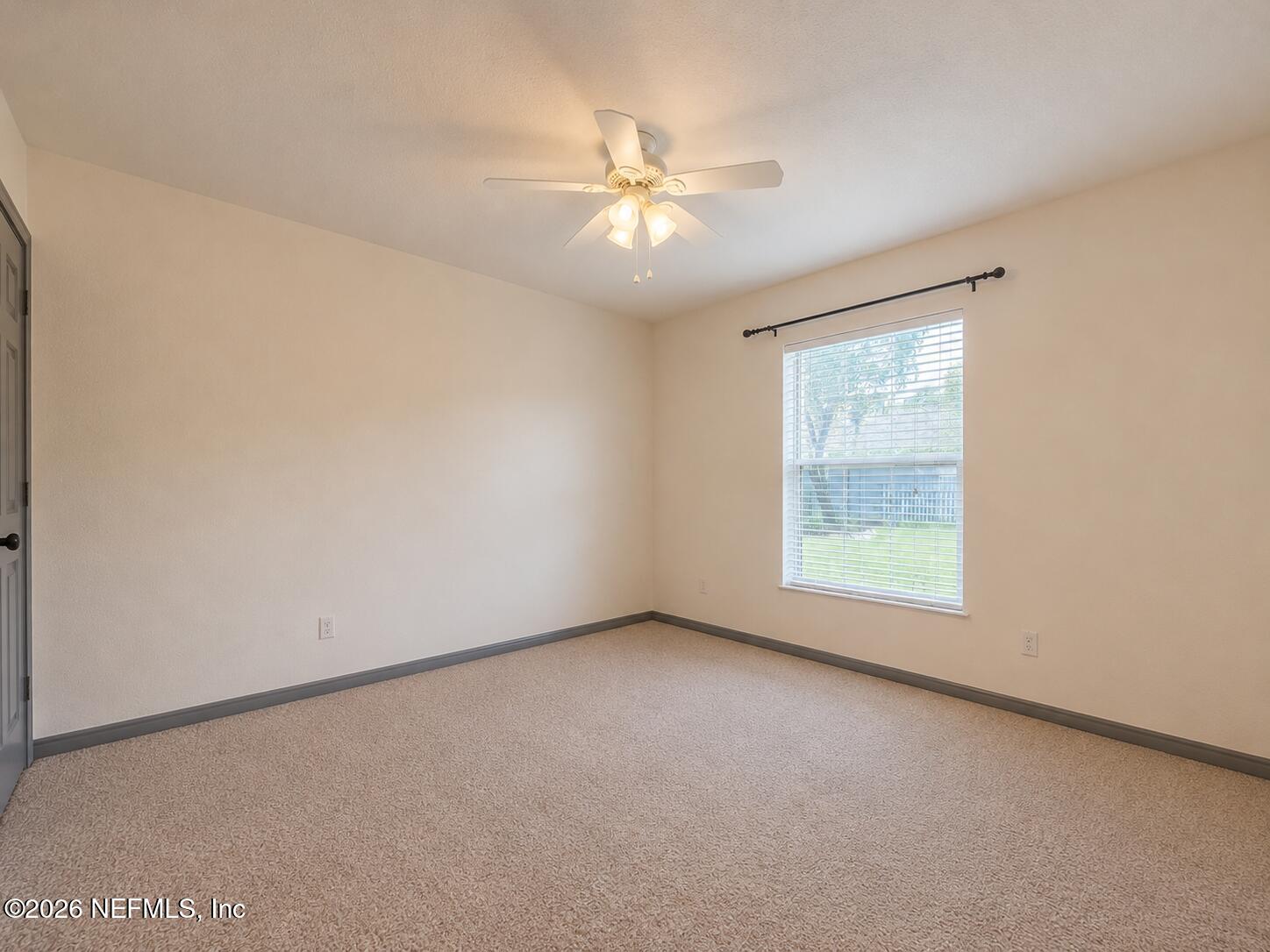 4728 Innisbrook Court North Elkton, FL 32033 - Photo 25 of 28 an empty room with a window and a fan
