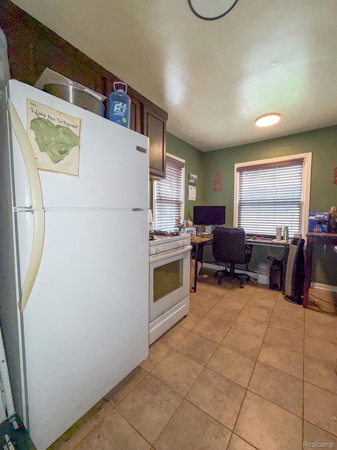 24811 Valley Avenue Eastpointe, MI 48021 - Photo 7 of 22 Kitchen with white appliances, an office area, and light tile patterned floors