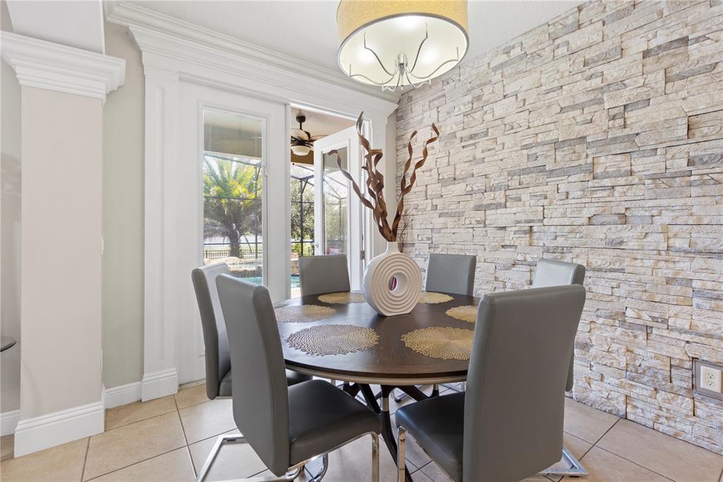 1445 Via Sangro Place Winter Park, FL 32792 - Photo 13 of 58 a view of a dining room with furniture and wooden floor