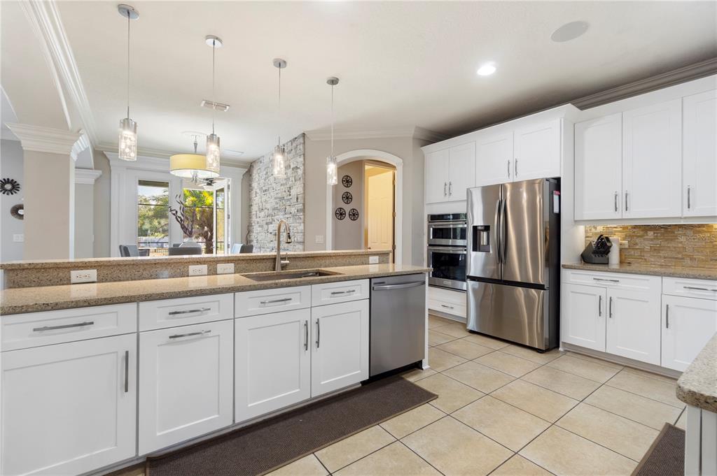 1445 Via Sangro Place Winter Park, FL 32792 - Photo 15 of 58 a kitchen with stainless steel appliances granite countertop a refrigerator and a sink