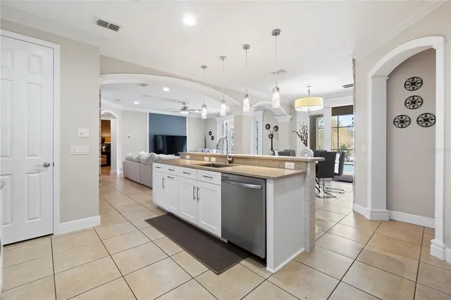 a large white kitchen with a large window