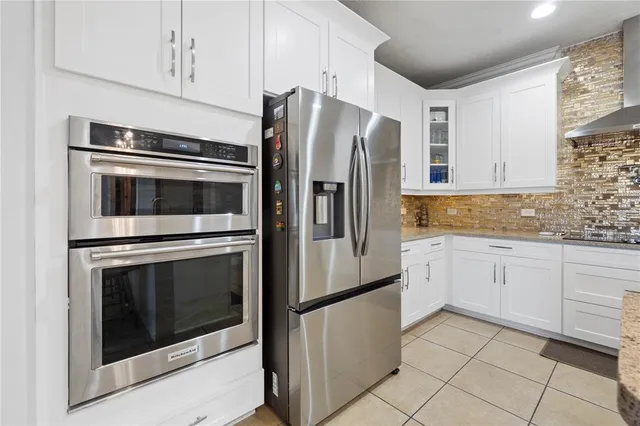 a kitchen with stainless steel appliances granite countertop a refrigerator stove and sink