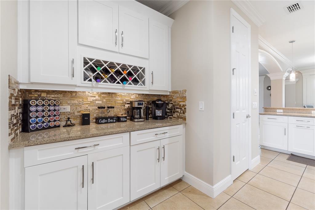 1445 Via Sangro Place Winter Park, FL 32792 - Photo 19 of 58 a kitchen with white cabinets and window