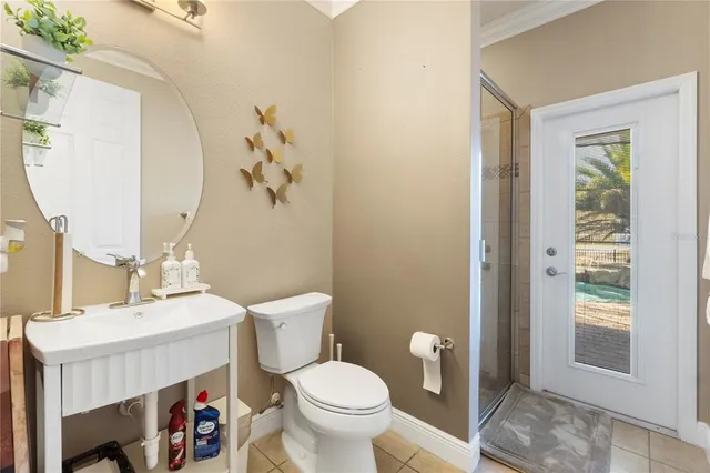 a bathroom with a toilet a sink and a mirror