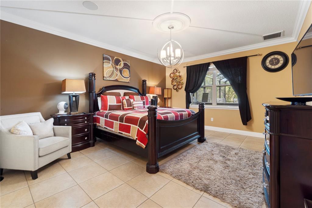 1445 Via Sangro Place Winter Park, FL 32792 - Photo 24 of 58 a bed room with a bed and a chandelier