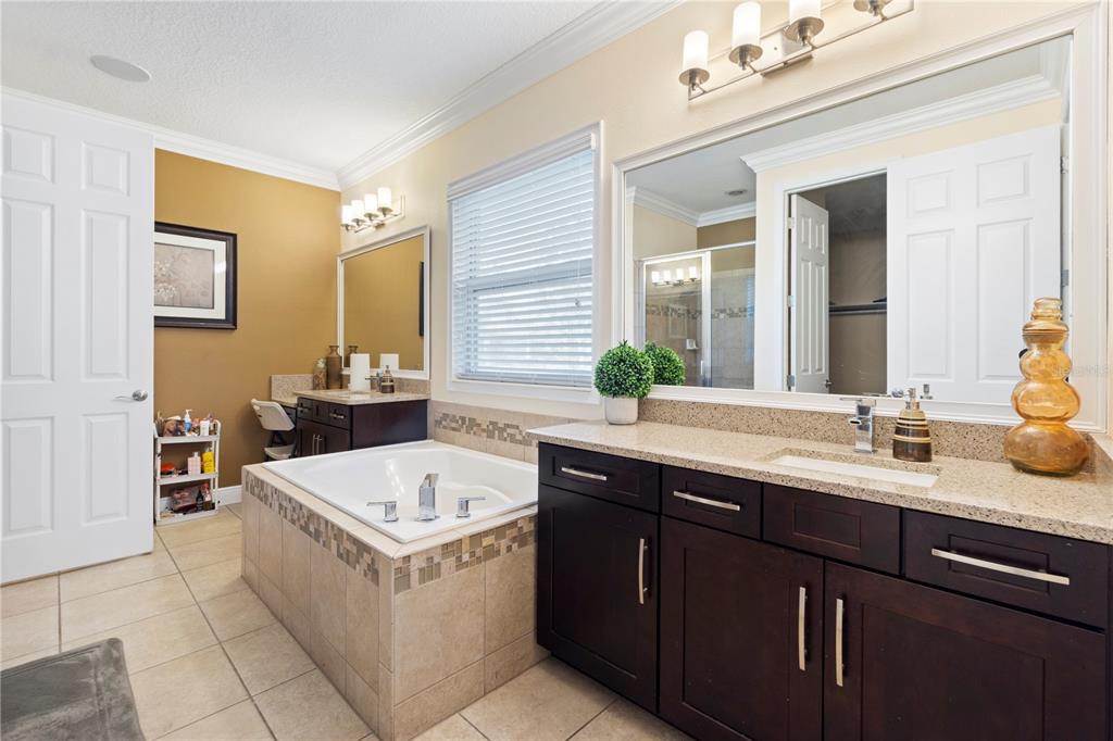 1445 Via Sangro Place Winter Park, FL 32792 - Photo 25 of 58 a bathroom with a tub sink and mirror