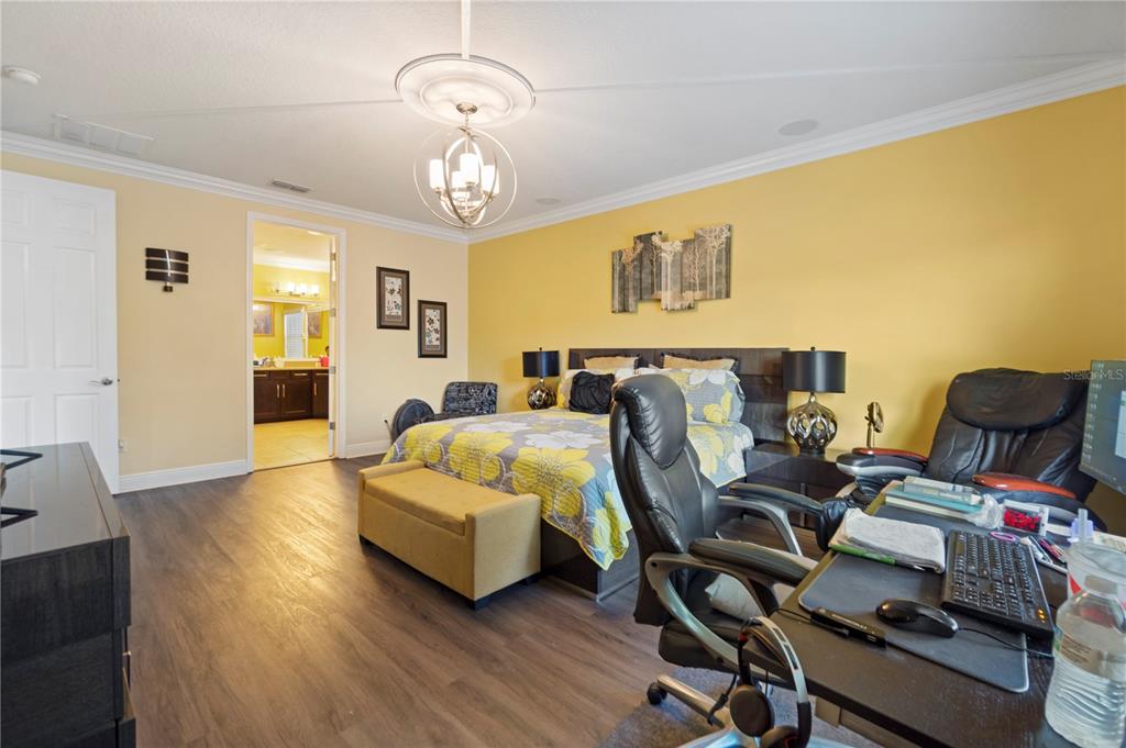 1445 Via Sangro Place Winter Park, FL 32792 - Photo 31 of 58 a bedroom with a bed and wooden floor