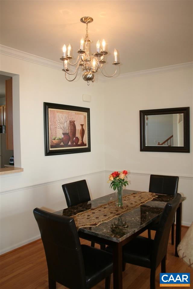 323 Rolkin Road Charlottesville, VA 22911 - Photo 12 of 47 a view of a dining room with furniture a chandelier and wooden floor