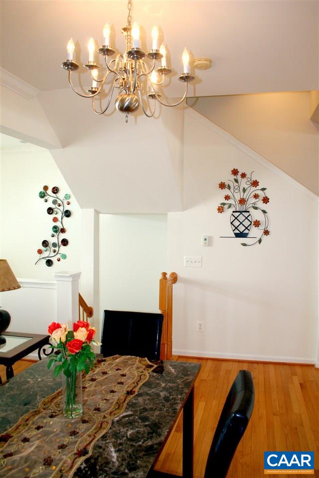 323 Rolkin Road Charlottesville, VA 22911 - Photo 14 of 47 a bedroom with a bed and a chandelier