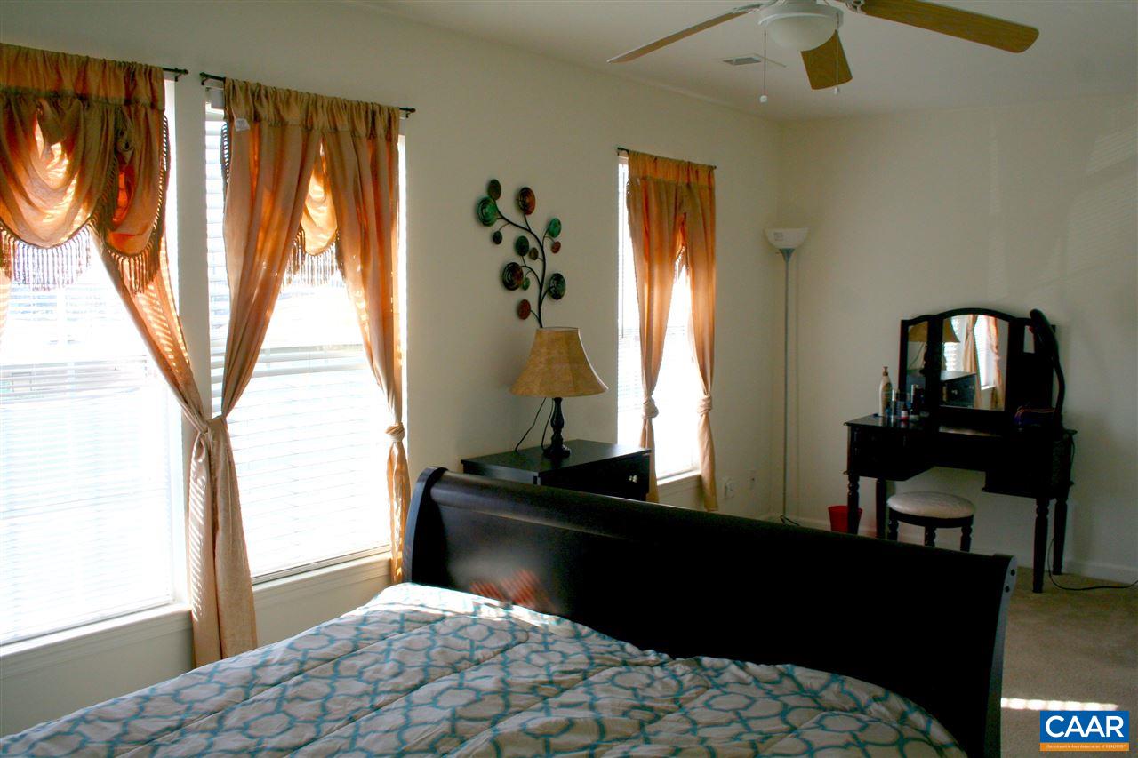 323 Rolkin Road Charlottesville, VA 22911 - Photo 19 of 47 a bedroom with a bed and large windows