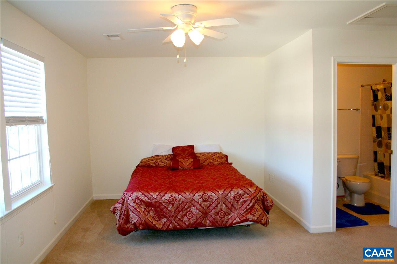 323 Rolkin Road Charlottesville, VA 22911 - Photo 31 of 47 a bedroom with a bed and a chandelier fan