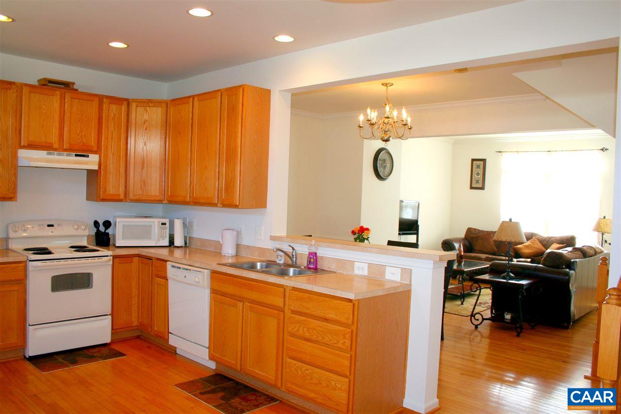 323 Rolkin Road Charlottesville, VA 22911 - Photo 5 of 47 a kitchen with a sink stove and wooden cabinets