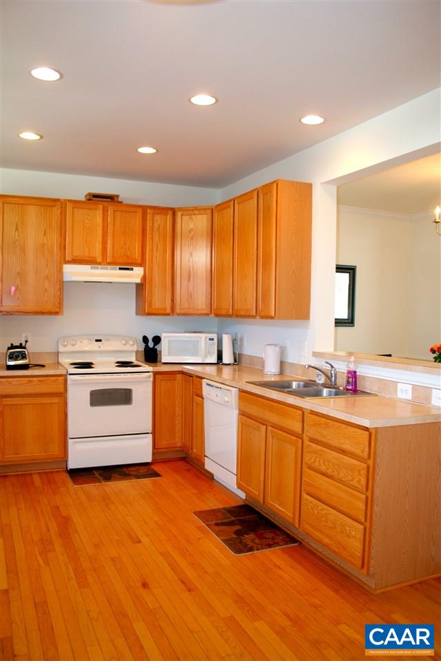 323 Rolkin Road Charlottesville, VA 22911 - Photo 6 of 47 a kitchen with stainless steel appliances granite countertop a stove and white cabinets