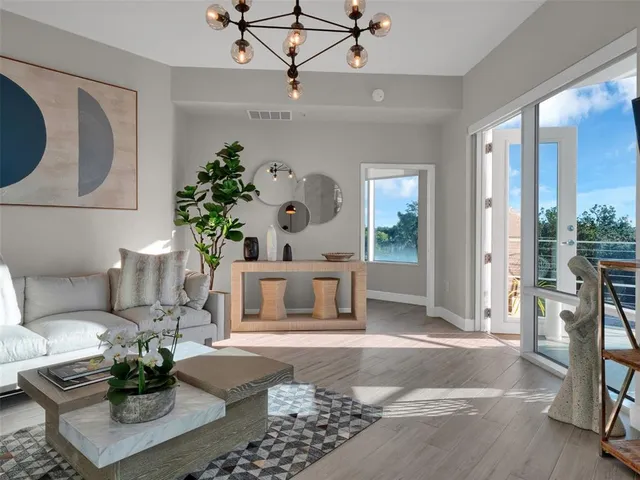 a living room with furniture and wooden floor