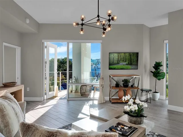 a living room with furniture rug and wooden floor