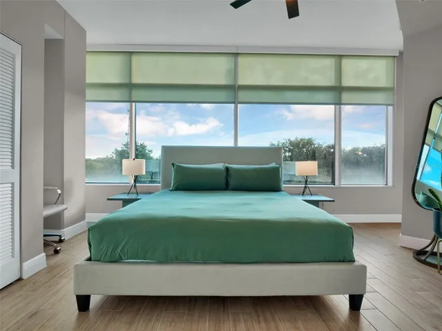 a bathroom with a granite countertop shower a sink and a toilet