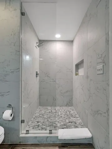 a kitchen with kitchen island a counter top space cabinets and stainless steel appliances