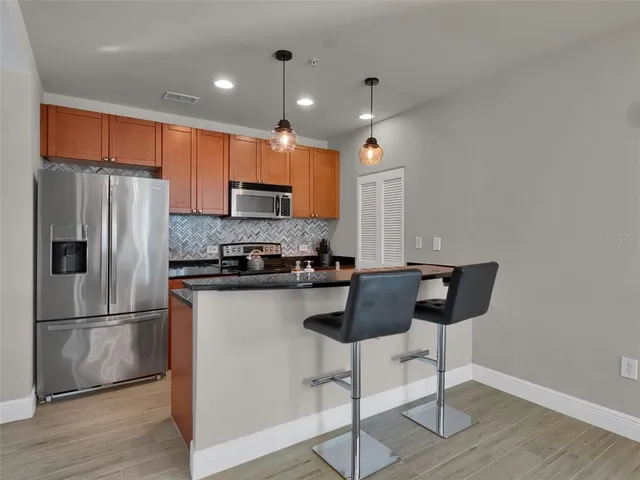 a view of a room with wooden floor and potted plant