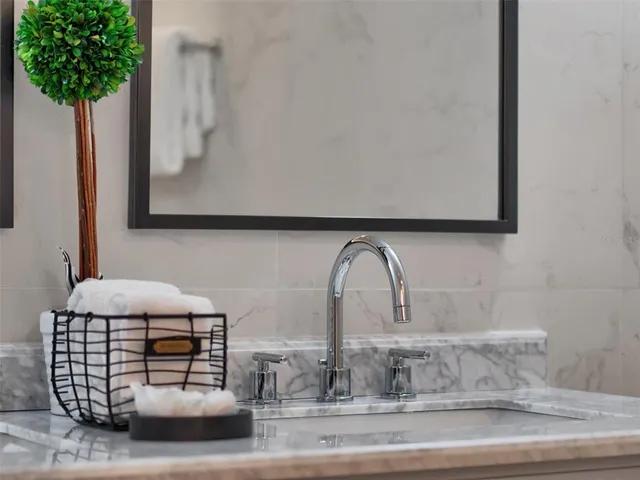 a bed room with a bed and a chair