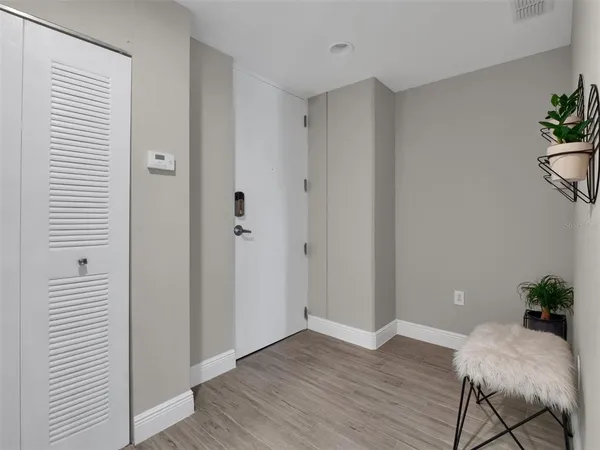 a bed room with a bed and a flat tv screen