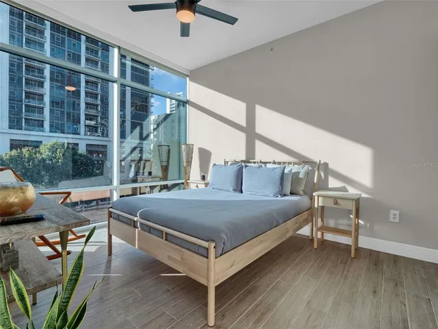 a view of a livingroom with lounge chair and a large window