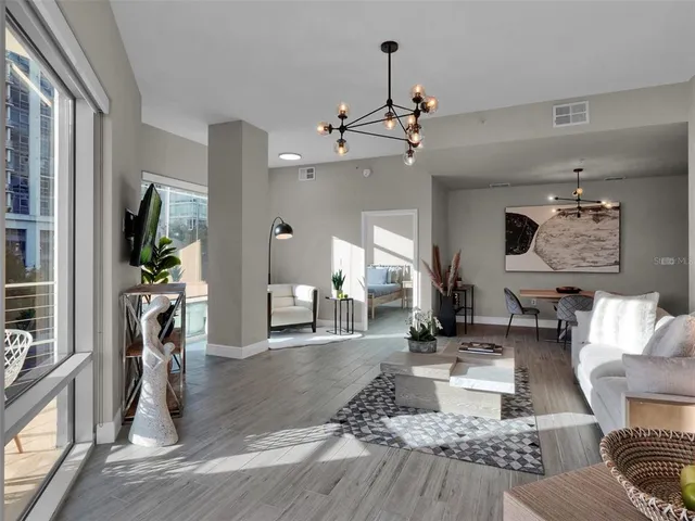 a living room with furniture and a potted plant