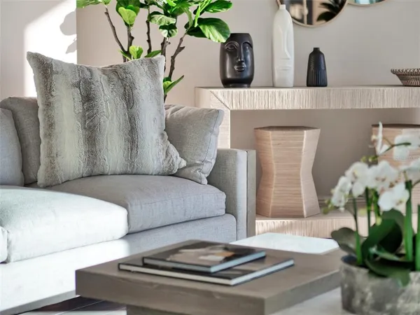 a dining hall with stainless steel appliances kitchen island granite countertop a table chairs and a glass door