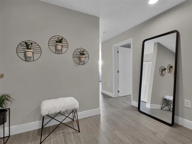 a living room with furniture and floor to ceiling windows