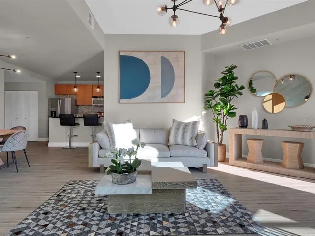 a living room with furniture and a chandelier