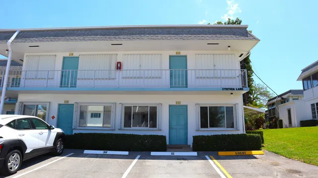a front view of a building with parking space