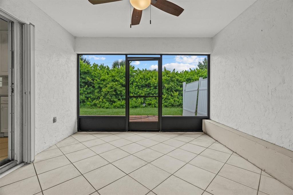 2660 Lear Road Englewood, FL 34224 - Photo 11 of 42 a view of an empty room with a large window with kitchen view