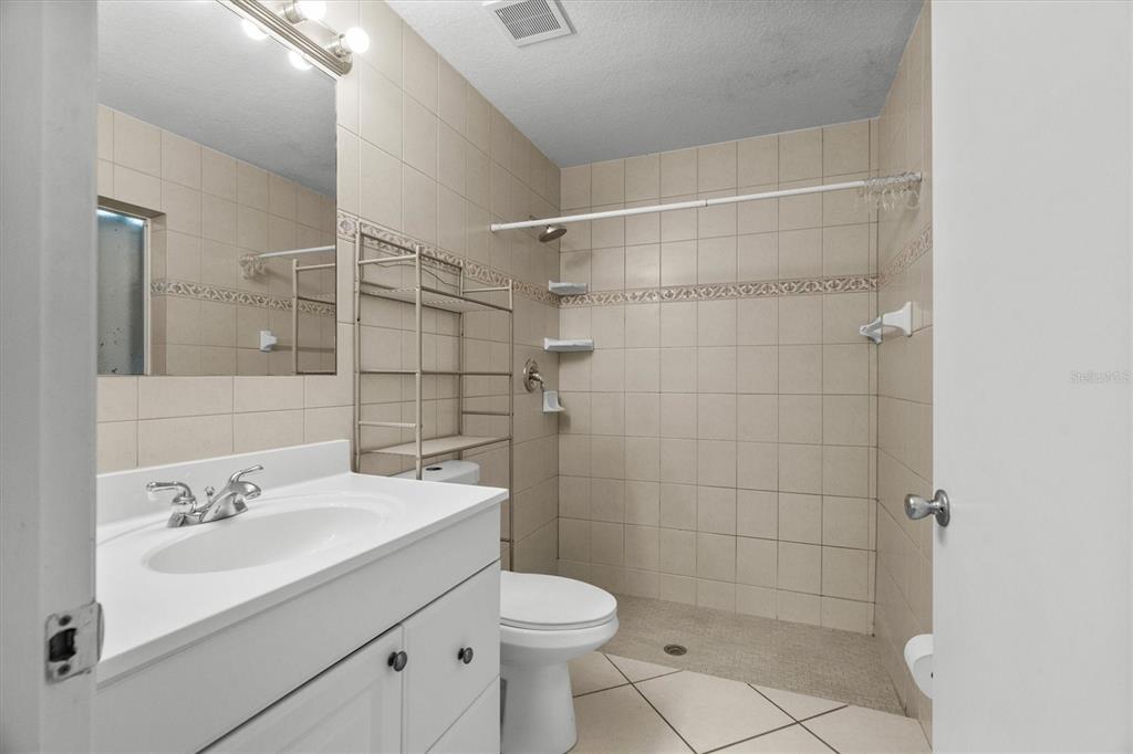 2660 Lear Road Englewood, FL 34224 - Photo 19 of 42 a bathroom with a sink toilet and shower