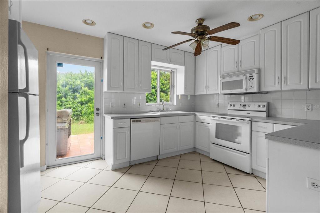 2660 Lear Road Englewood, FL 34224 - Photo 25 of 42 a kitchen with a stove a sink and a window