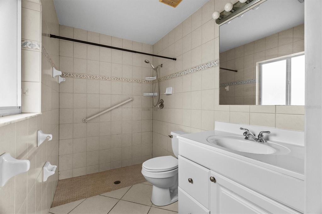 2660 Lear Road Englewood, FL 34224 - Photo 29 of 42 a bathroom with a sink a toilet and shower