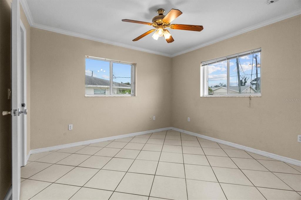 2660 Lear Road Englewood, FL 34224 - Photo 30 of 42 a view of an empty room with window and chandelier fan