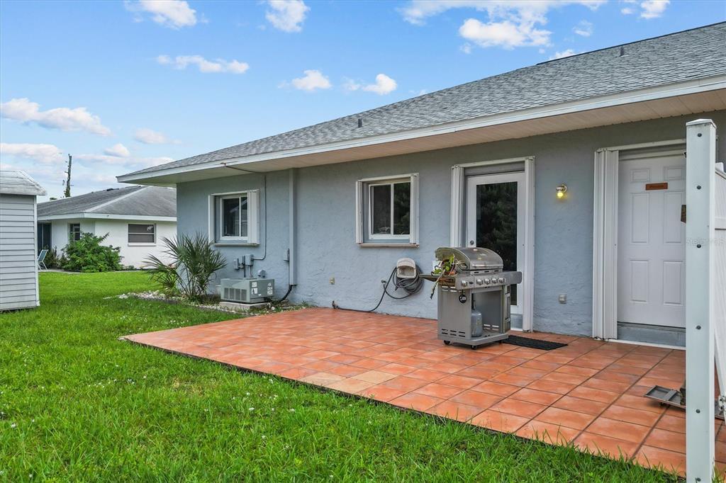2660 Lear Road Englewood, FL 34224 - Photo 34 of 42 a backyard of a house with yard fire pit and outdoor seating
