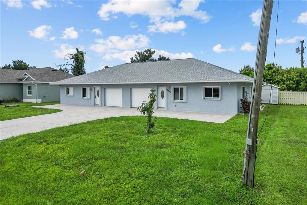 2660 Lear Road Englewood, FL 34224 - Photo 4 of 42 a front view of house with yard and green space