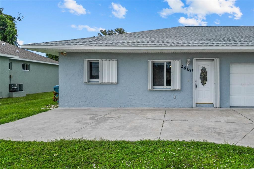 2660 Lear Road Englewood, FL 34224 - Photo 5 of 42 a front view of a house with a yard