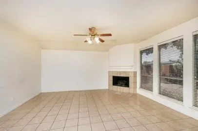 wooden floor fireplace and windows in an empty room