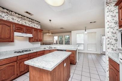 2100 Cantura Drive Mesquite, TX 75181 - Photo 4 of 10 a kitchen with stainless steel appliances granite countertop a sink stove and cabinets