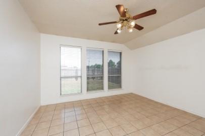 2100 Cantura Drive Mesquite, TX 75181 - Photo 5 of 10 an empty room with chandelier fan and windows