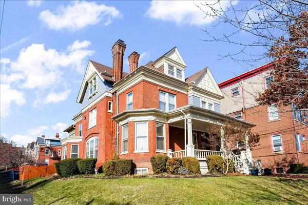 a front view of a residential houses with yard
