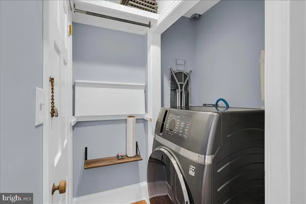 a utility room with closet dryer and washer