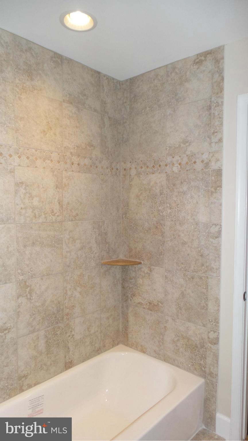 13409 Bladon Road Phoenix, MD 21131 - Photo 13 of 27 a bathroom with a bathtub