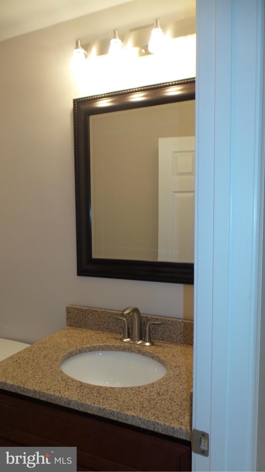 13409 Bladon Road Phoenix, MD 21131 - Photo 19 of 27 a bathroom with a granite countertop sink and a mirror